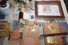 Worktop with some gold, gilding tools and other bits and pieces -